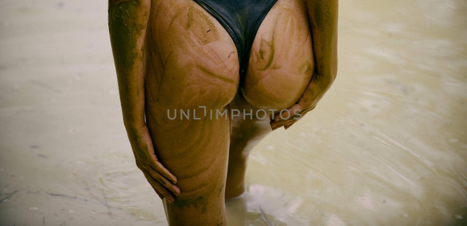 Dirty ass female in panties. Woman in the mud bath. Luxury ass. Huge mud buttocks. Sensual attractive mud womans ass. Spa procedure and body care. Enjoying mud