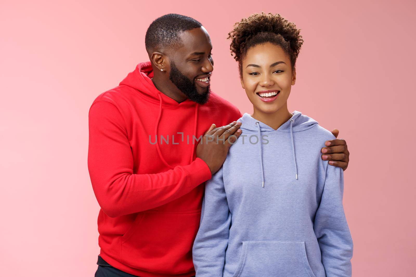 Supportive boyfriend congratulating girlfriend win first prize feel proud touching girl shoulder saying encouraging pleasant words smiling look caring lovely grinning, standing pink background by Benzoix