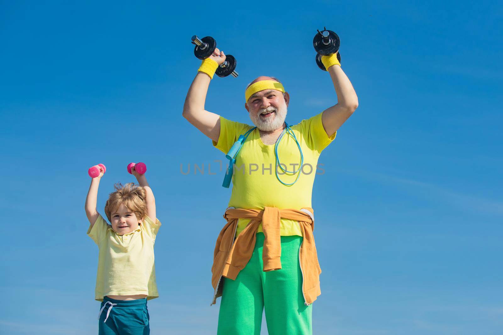 Grandfather and son doing exercises. Father and children having workout. Senior man and child in family health club. Sports for kids