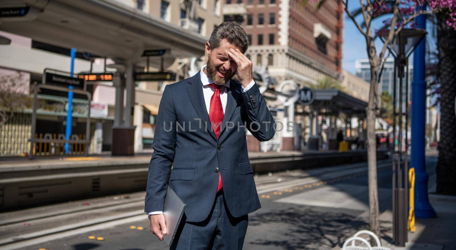 stressed freelance man hold pc outdoor, employer.