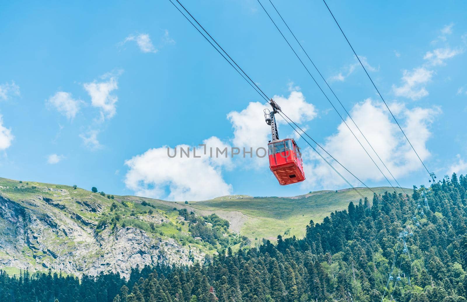 Old waggon moves along cable car in sunny weather