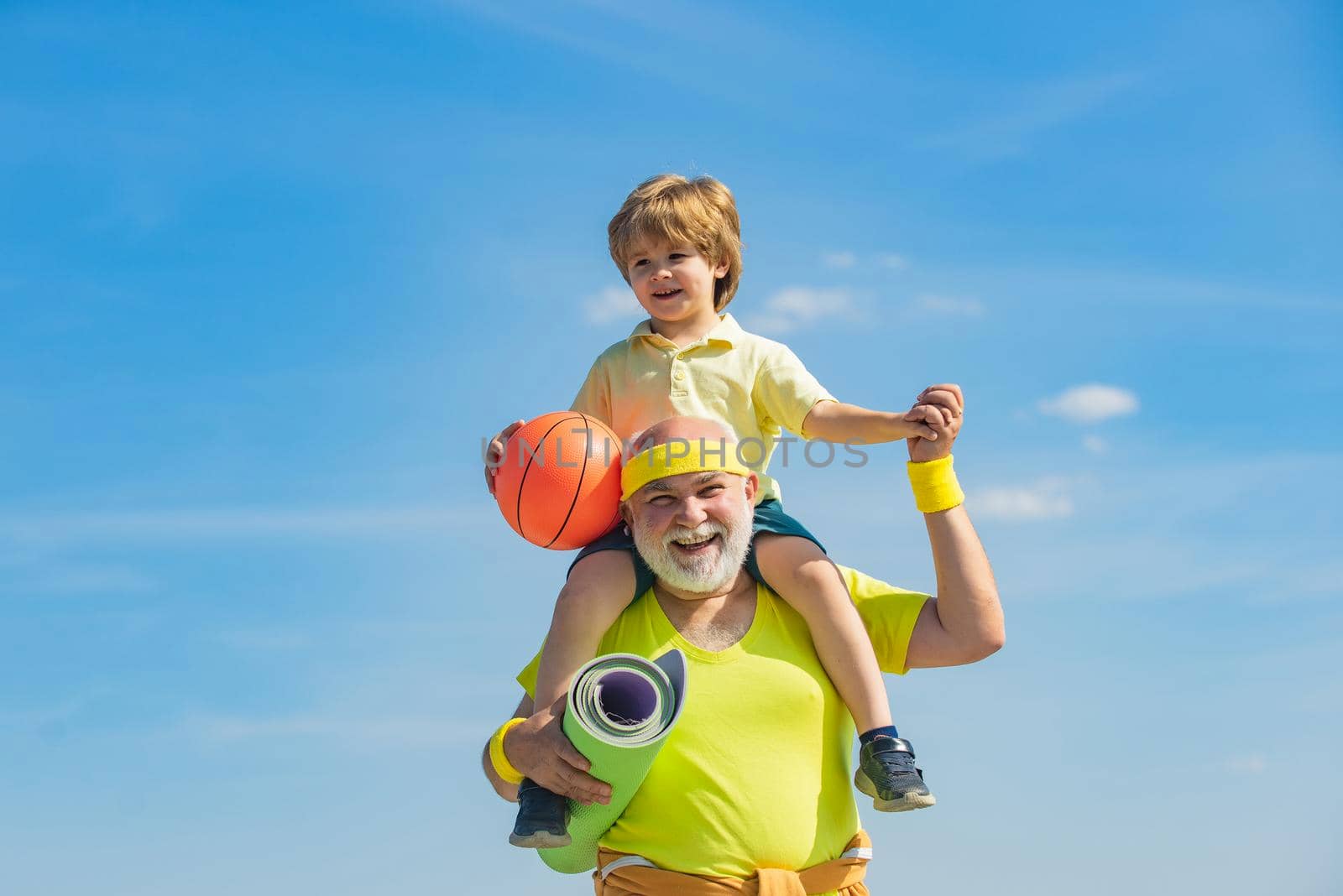 Grandpa and grandson spotting. Father and child training together. I love sport. Active family enjoy sport and fitness. Happy loving family