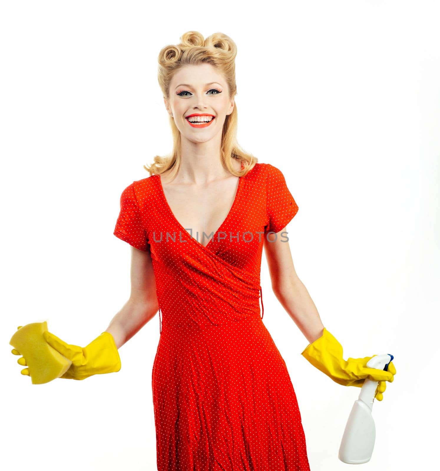 Pretty maid.Young beautiful woman holding spray. Isolated on a white background. Cleaning lady with a gloves in the hands