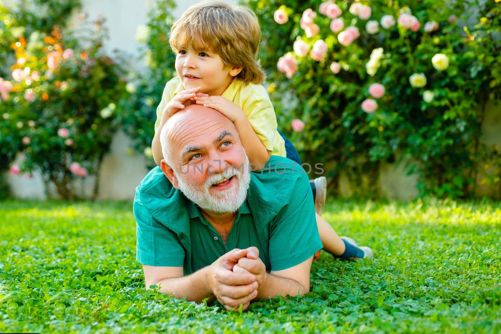 Happy grandfather and grandson relaxing together. Grandfather and grandson Playing - Family Time Together. Cute boy with dad playing outdoor. Father and grandfather