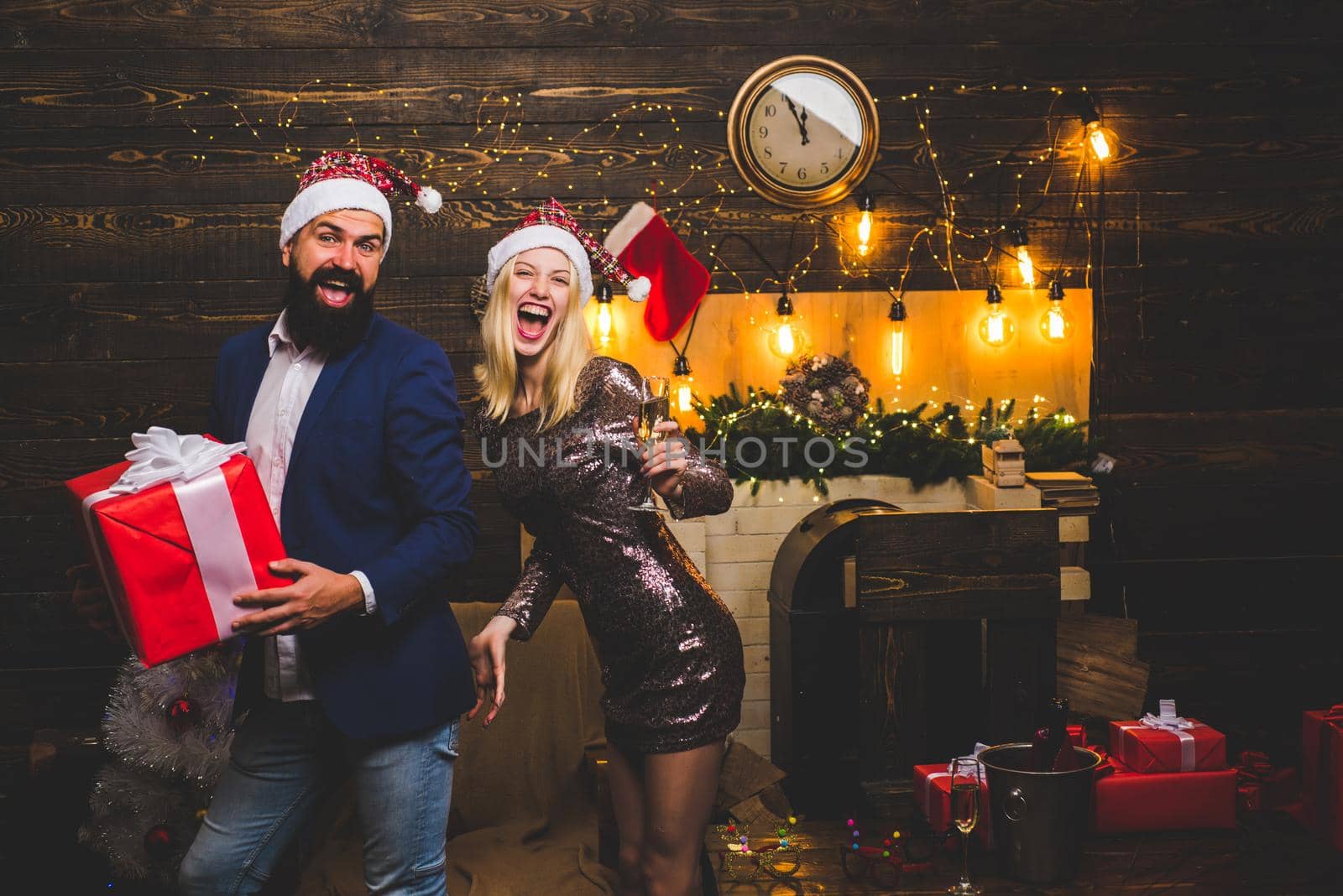 Portrait of a young beautiful smiling couple in home Christmas mood. Love. Positive human emotions facial expressions. Active couples celebrate Christmas. Sensual girl for Christmas