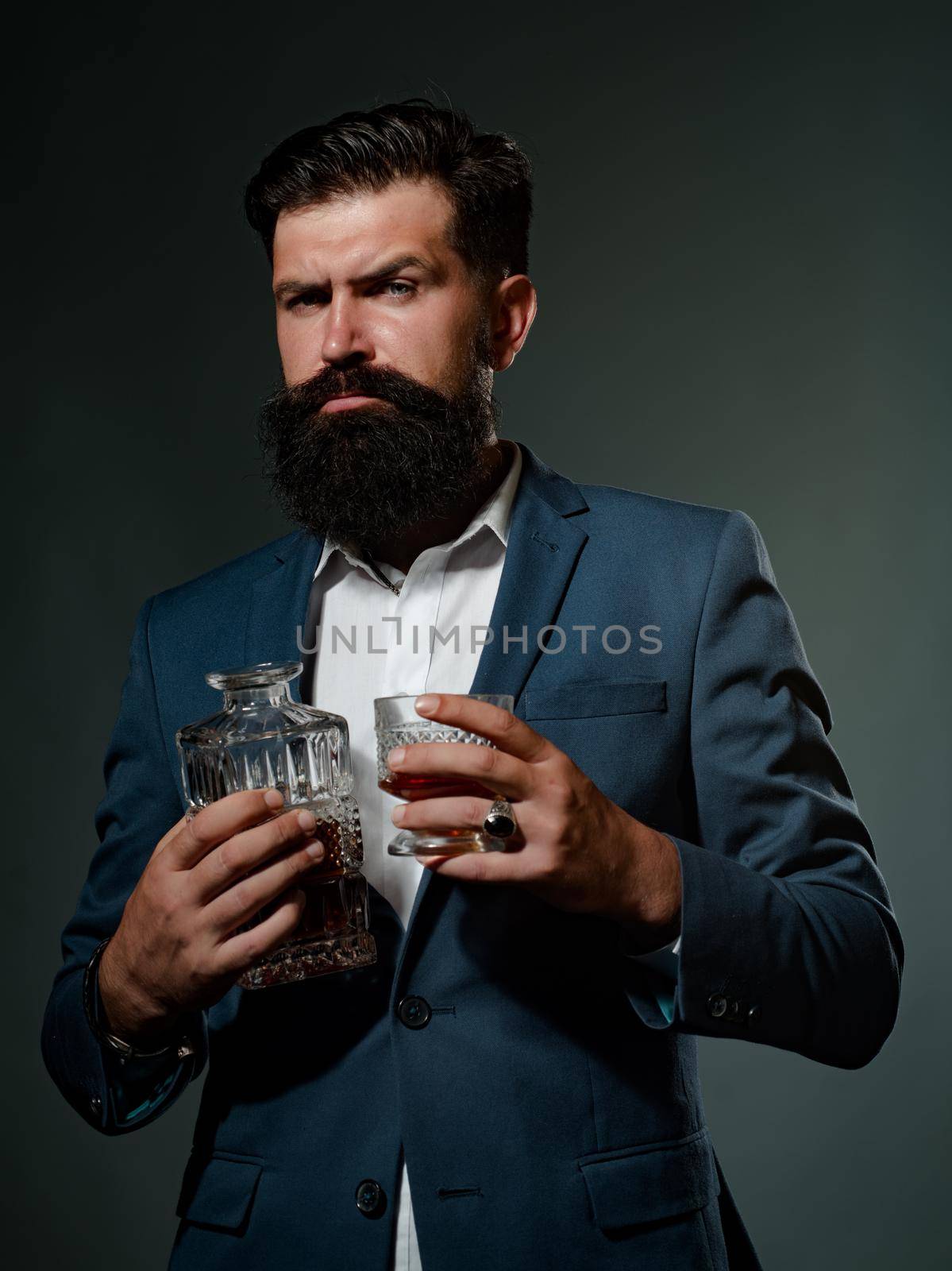 Fashionable man in white shirt and suspenders. Luxury beverage concept. Whisky elegant