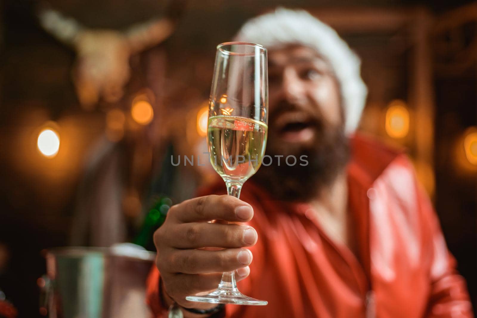 Happy new year. Time to drink. Manly brutal santa leather jacket. Brutal santa claus. Man bearded hipster santa with red hat celebrate with champagne drink. Christmas holiday. Lonely on christmas eve.