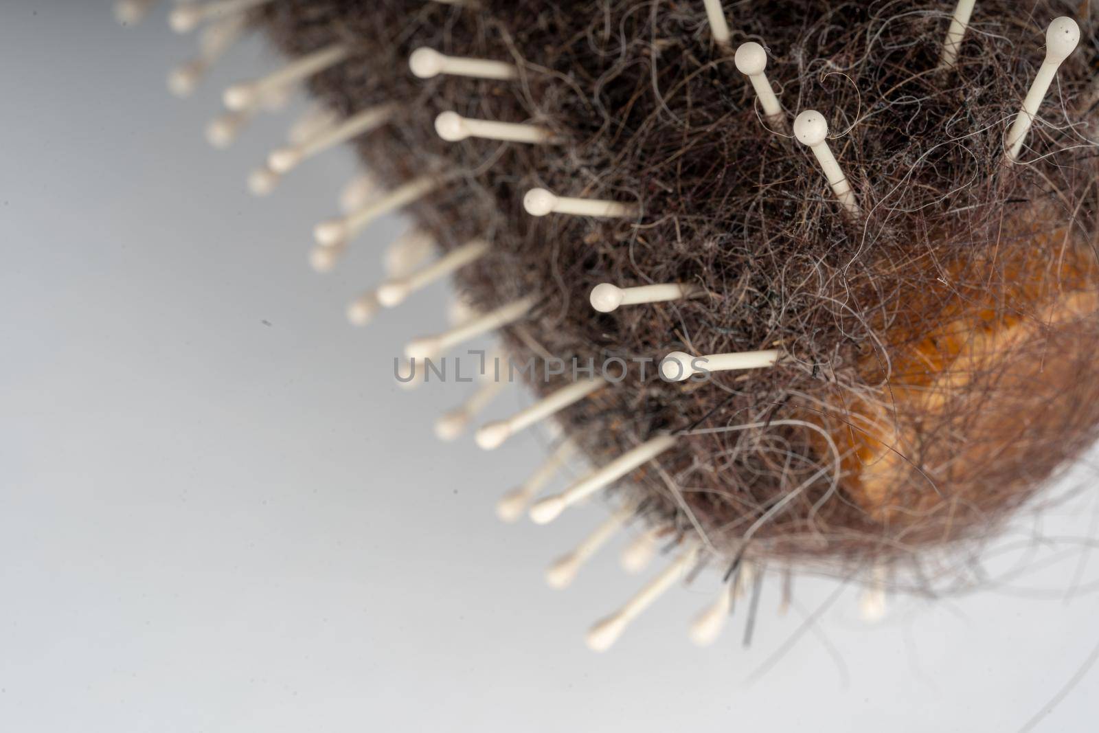 Close up of old dirty hairbrush. Comb with different hair on white background