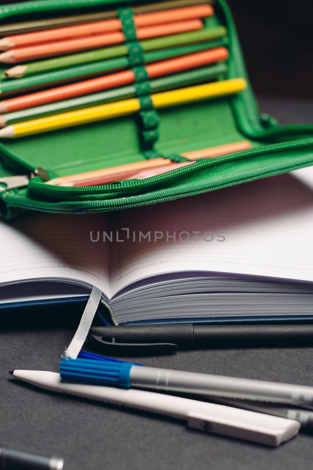 green pencil case with pencils design object school supplies. High quality photo