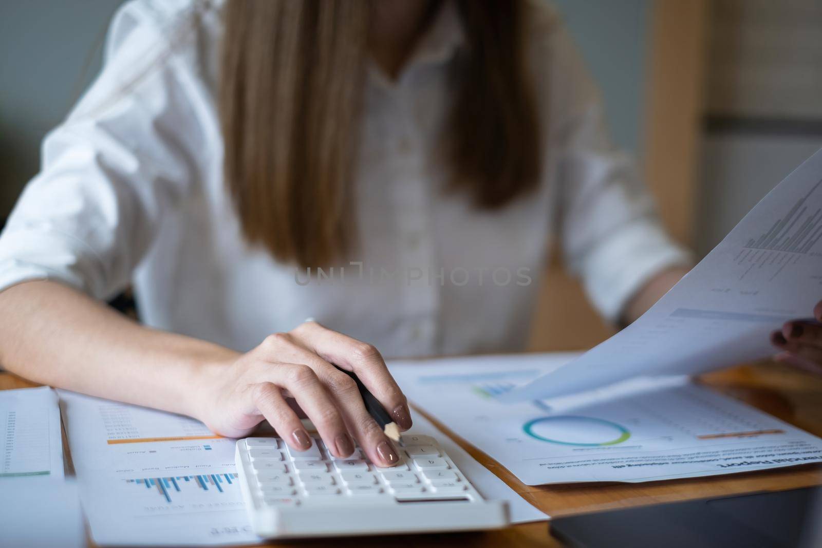 Close up Hand of Business woman working to analyze technical price graph and indicator. by itchaznong