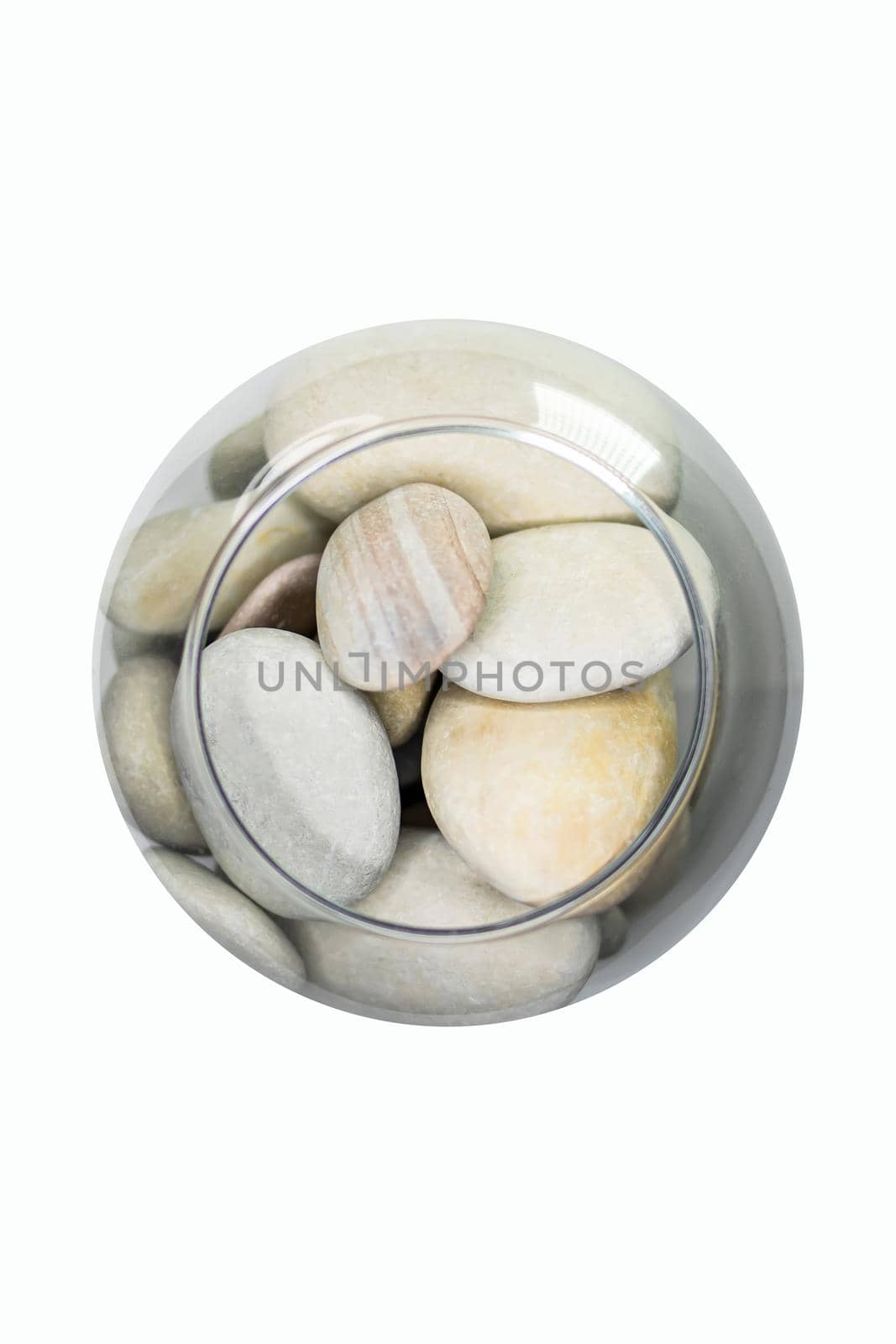 beautiful sea stones in a small aquarium on a white background top view.