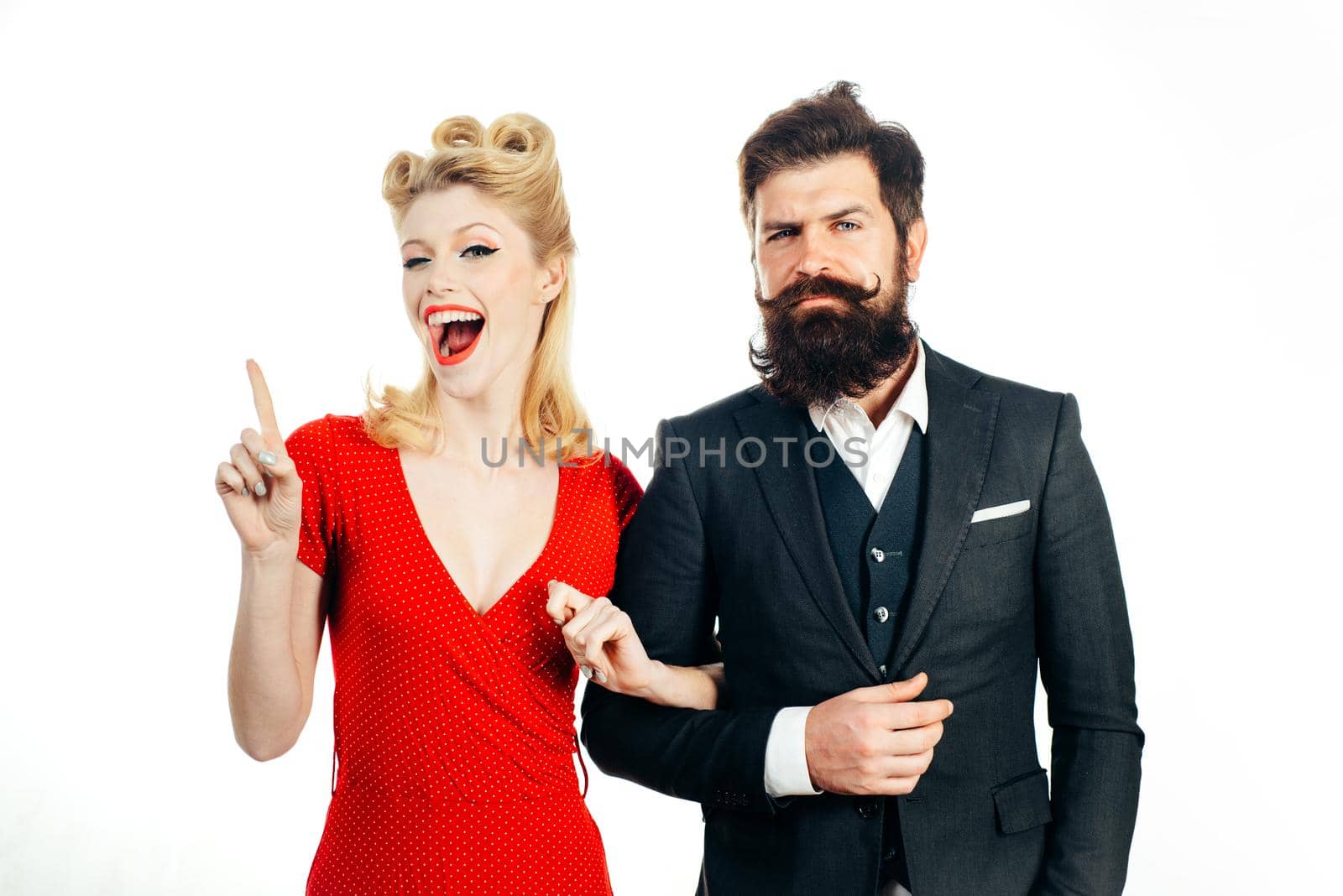 Funny retro couple. Family photo of emotional young couple isolated at white background. Blonde woman shows gesture that she has an interesting idea. Young couple in love forever