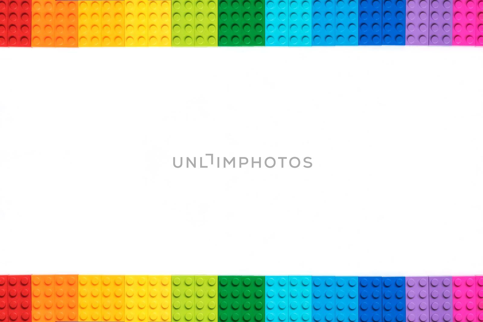 Multicolor lego constructor bricks on white background. Popular toys. Copyspace