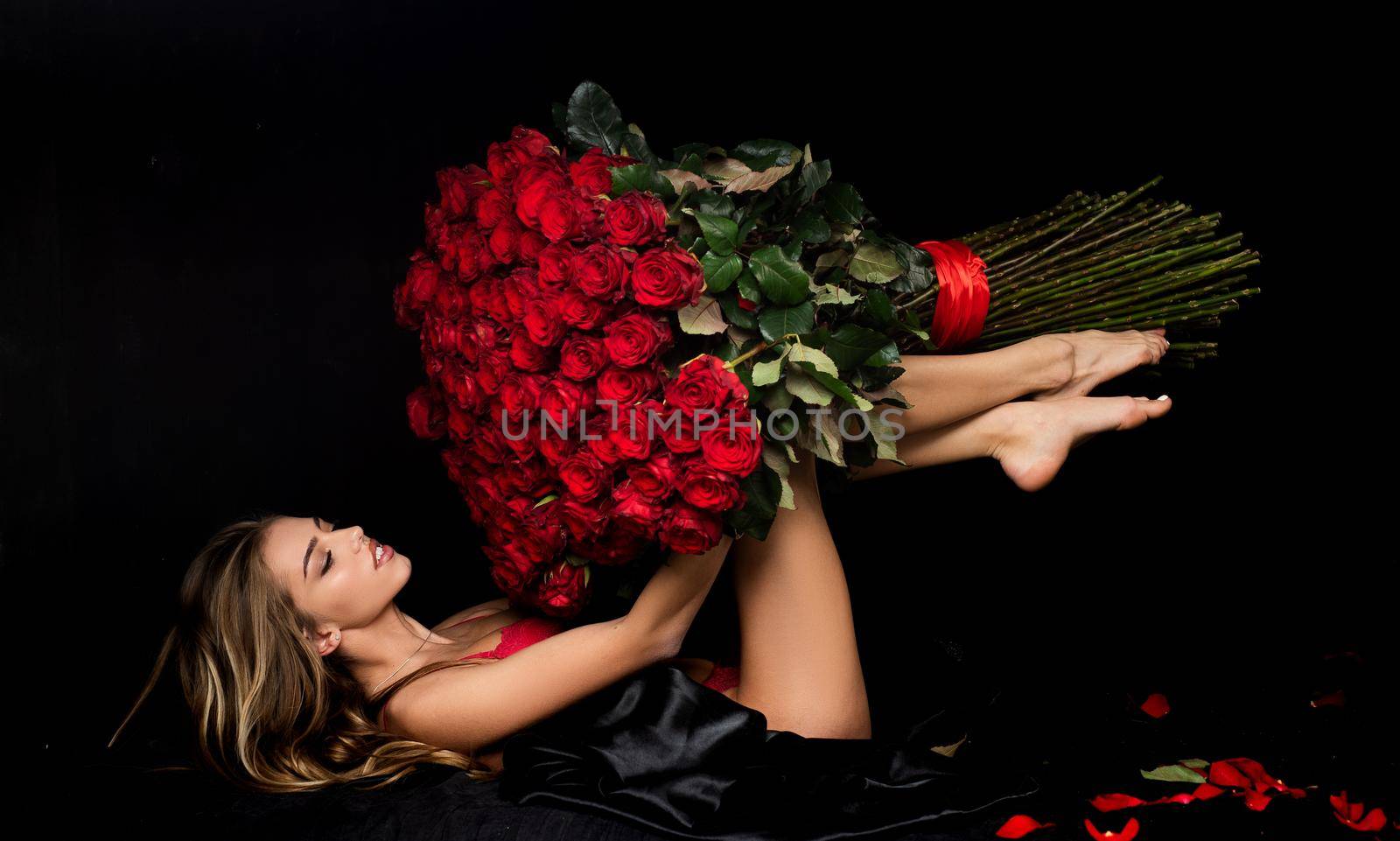 Beauty romantic woman with Red Rose flowers. Valentine. Fashion studio portrait of beautiful girl. Gift with love. Favorite flowers. by Tverdokhlib