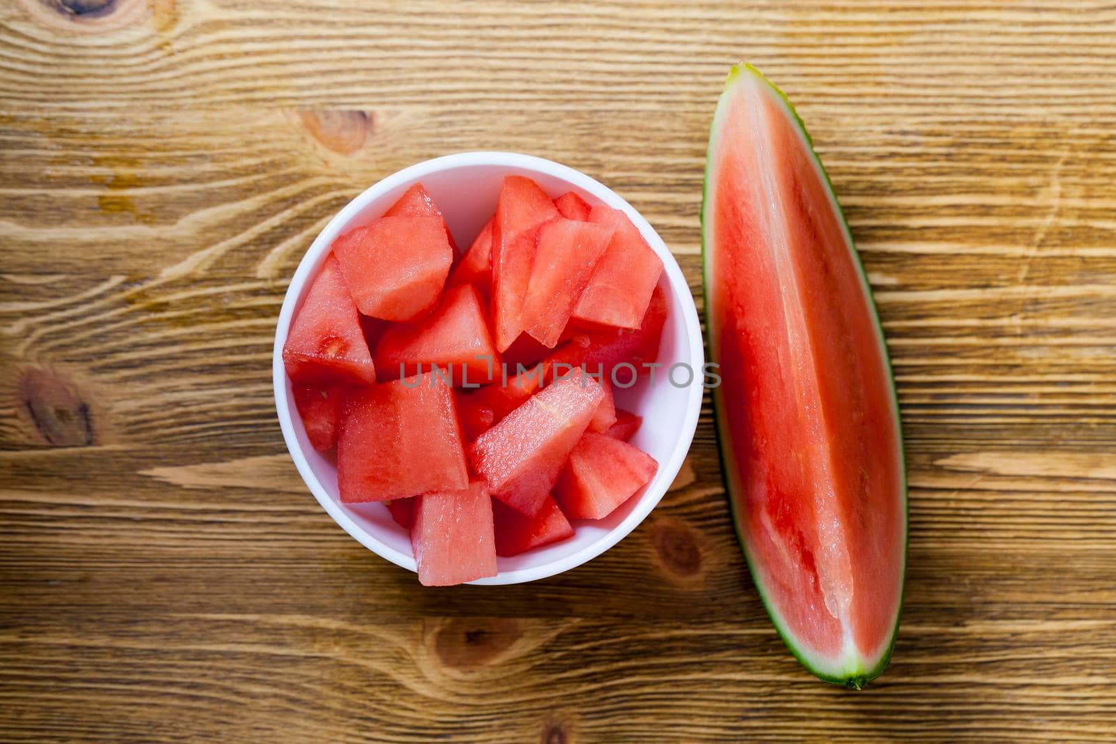 Ripe watermelon in a white plate. Against a blackboard background