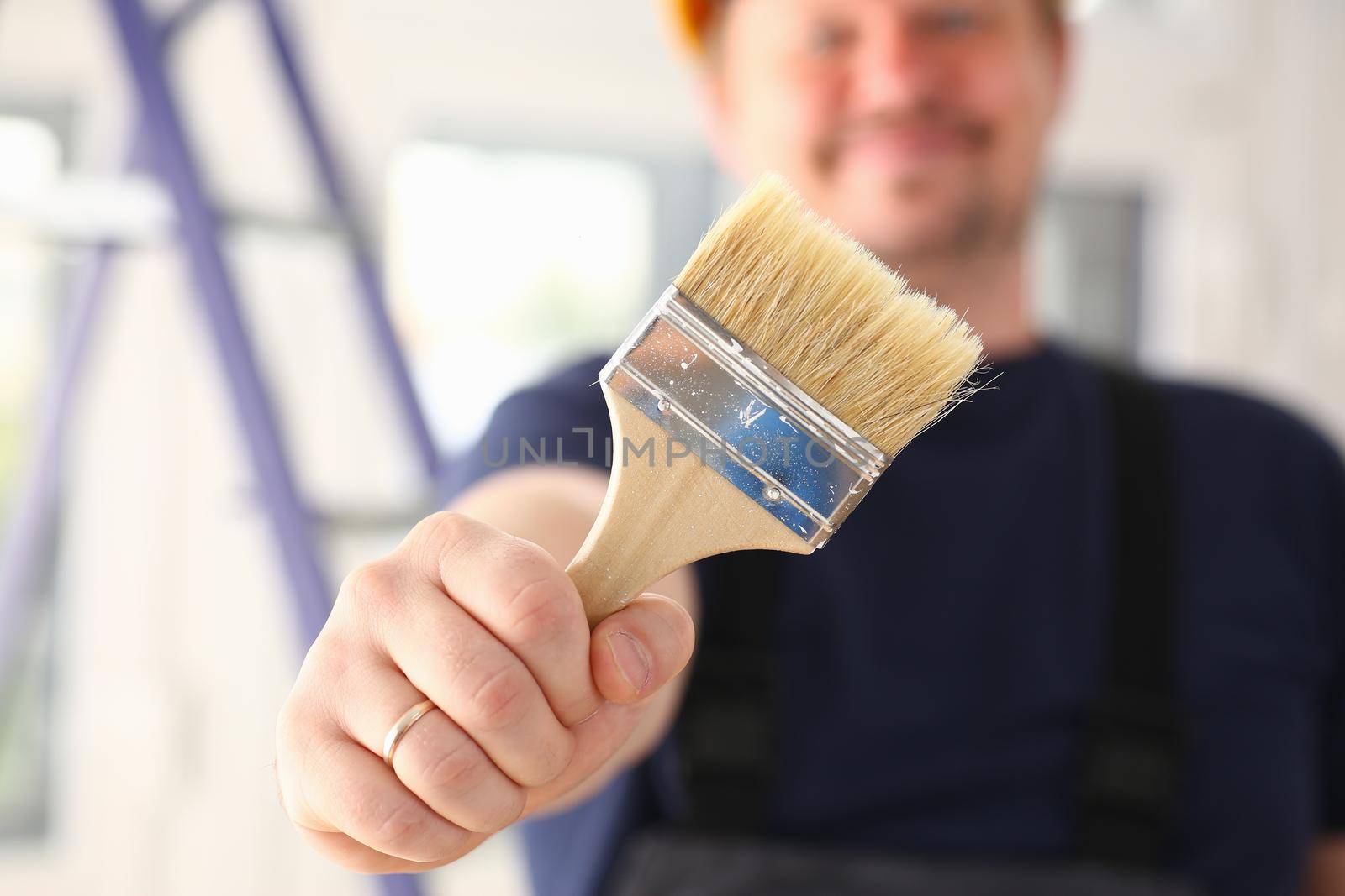 Arm of smiling worker hold brush closeup. Manual job workplace DIY inspiration improvement fix shop yellow helmet hard hat joinery startup idea industrial education profession career concept