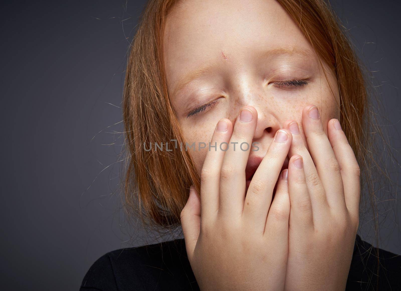 red-haired girl with freckles on her face in a black sweater posing by Vichizh