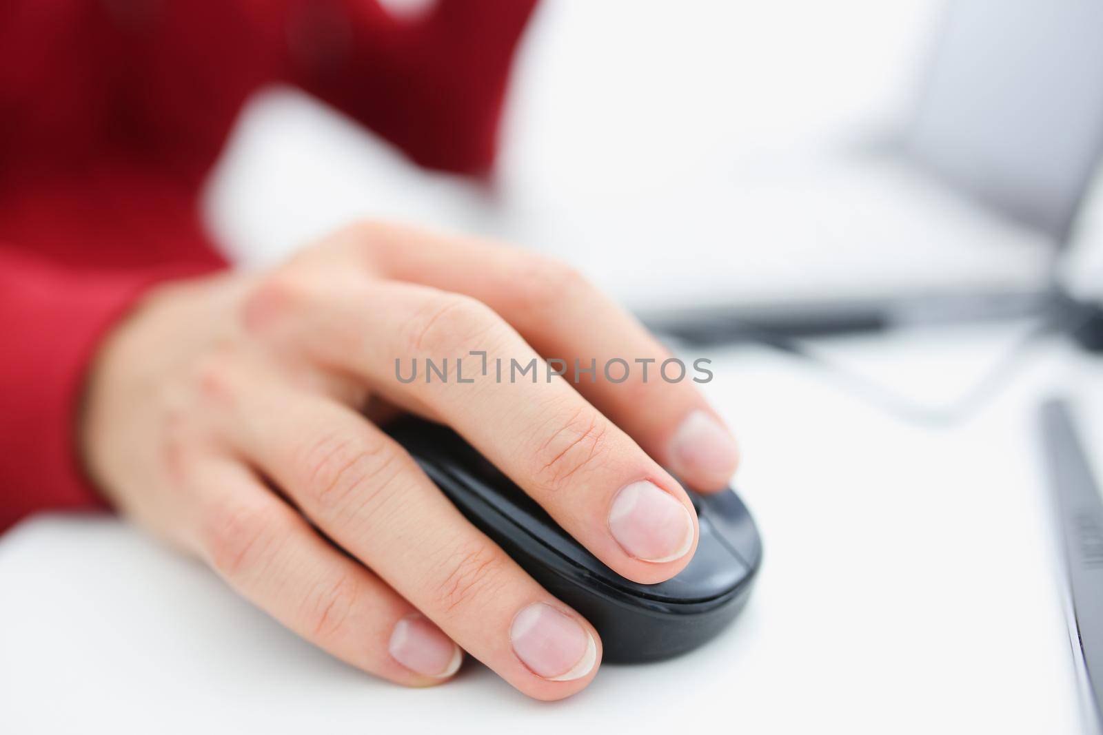 Male hand used computer mose holding in arm. Search for information for earnings in the Internet