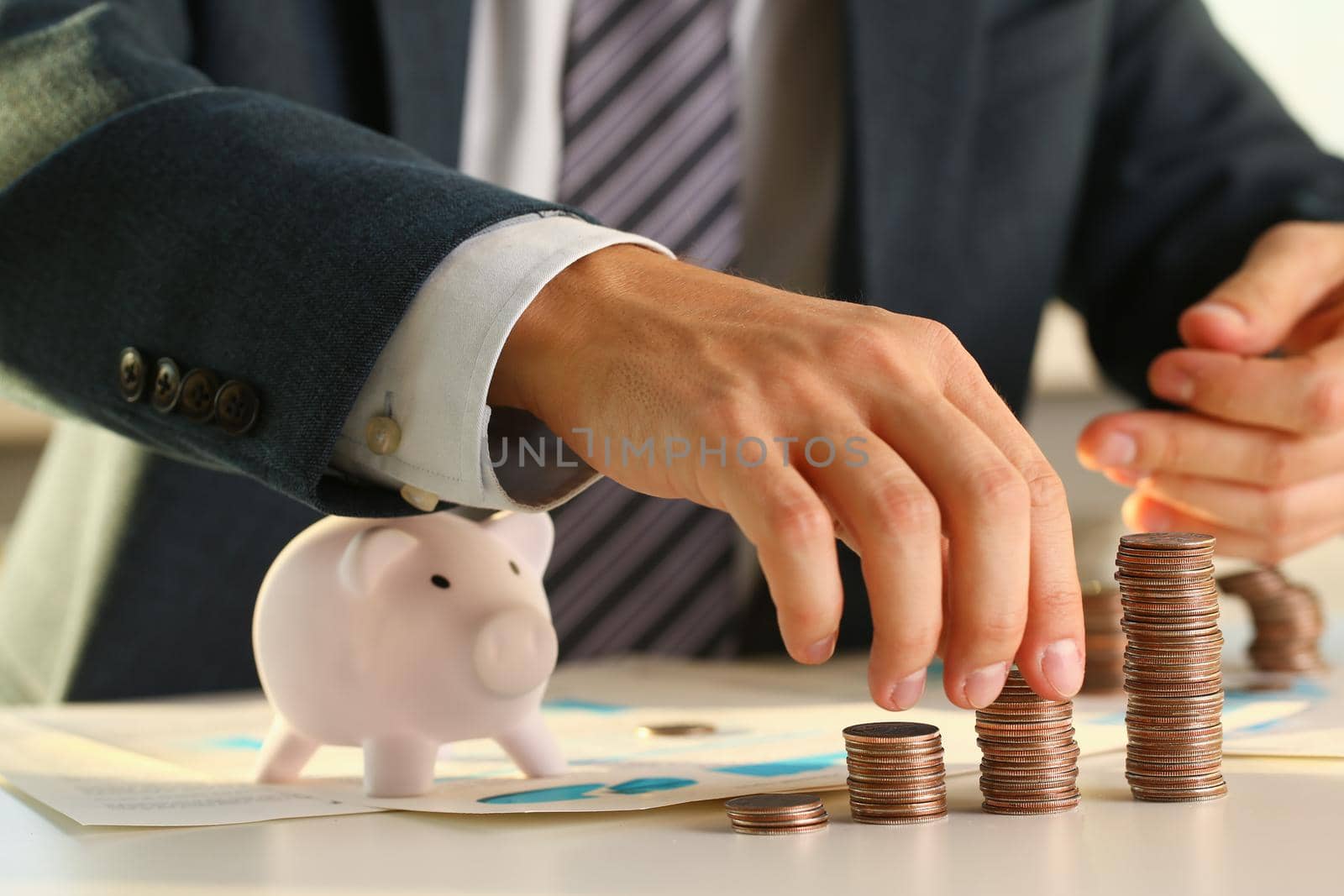 Hand businessman putting pin money into pig. Future needs loan education or mortgage credit spend vacation of dream effective buying financial risk and safety concept