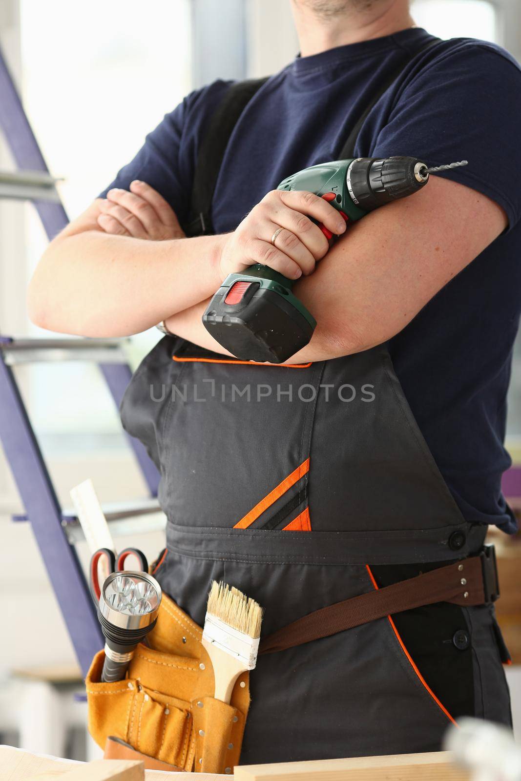 Arms of worker using electric drill closeup. Manual job DIY inspiration improvement job fix shop yellow helmet joinery startup idea industrial education profession career concept