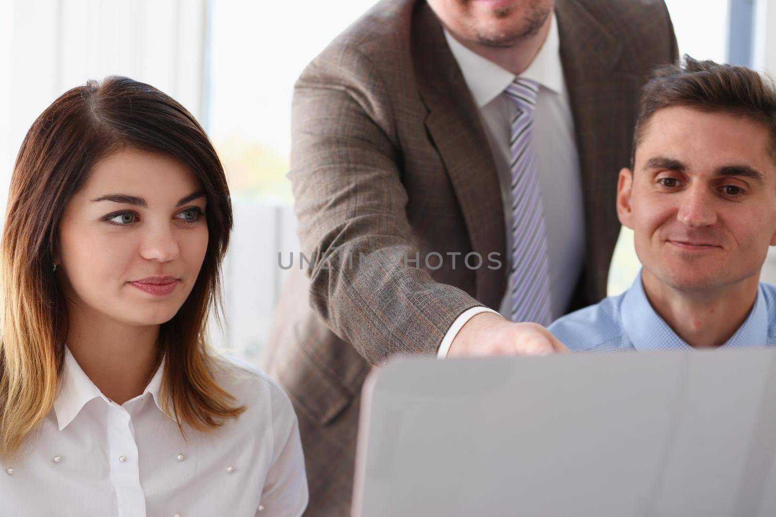 Beautiful smiling woman and man portrait at workplace by kuprevich