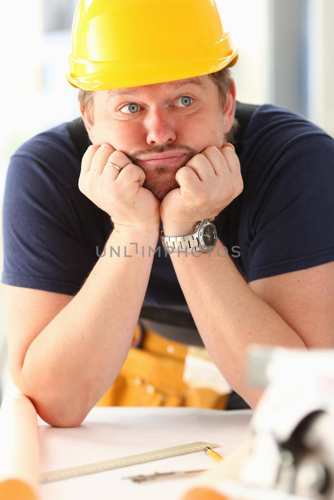 Thoughtful dummy funny worker in yellow helmet by kuprevich