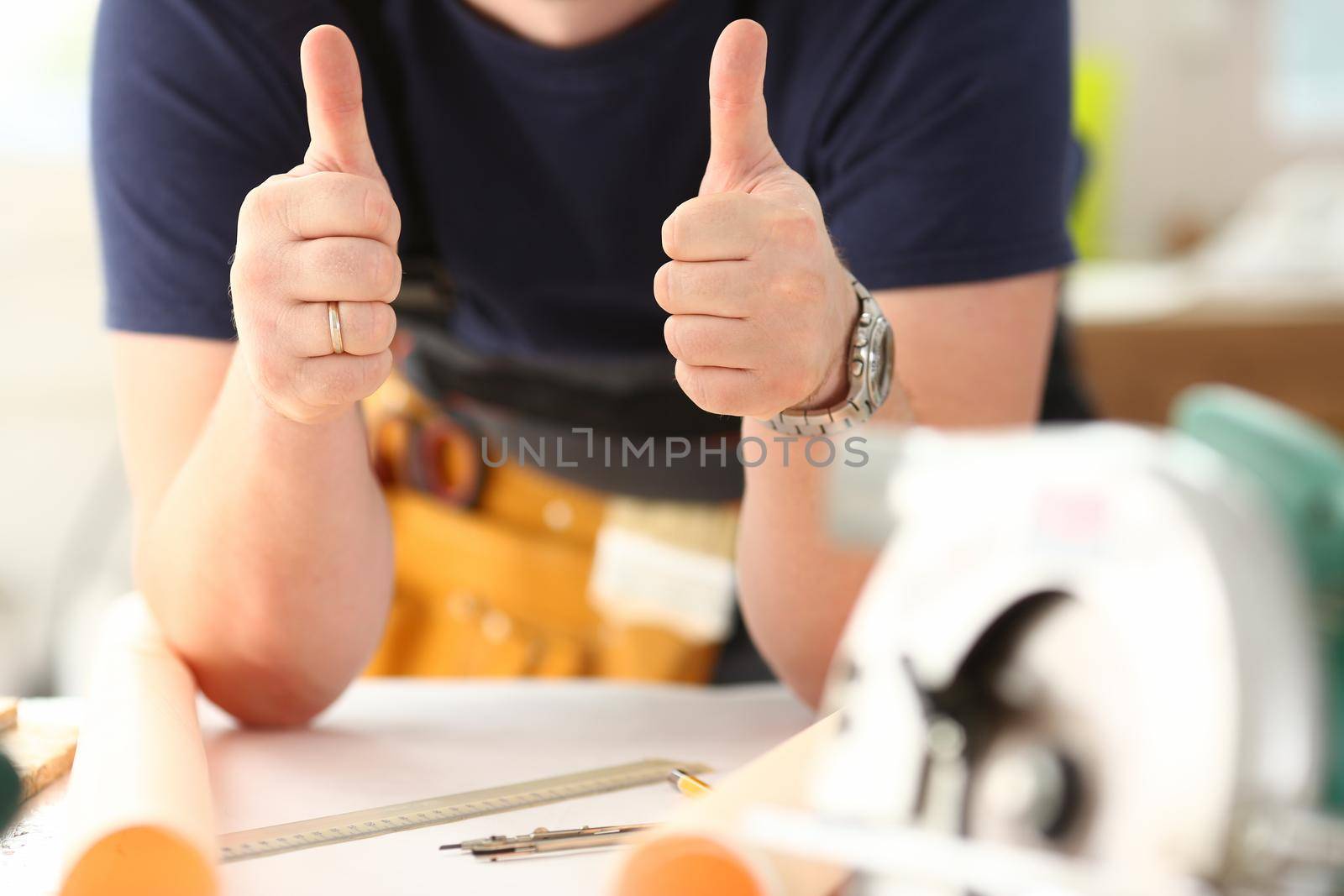 Arm of worker show confirm sign with thumb up closeup. Manual job DIY inspiration joinery startup idea fix shop hard hat industrial education profession career concept