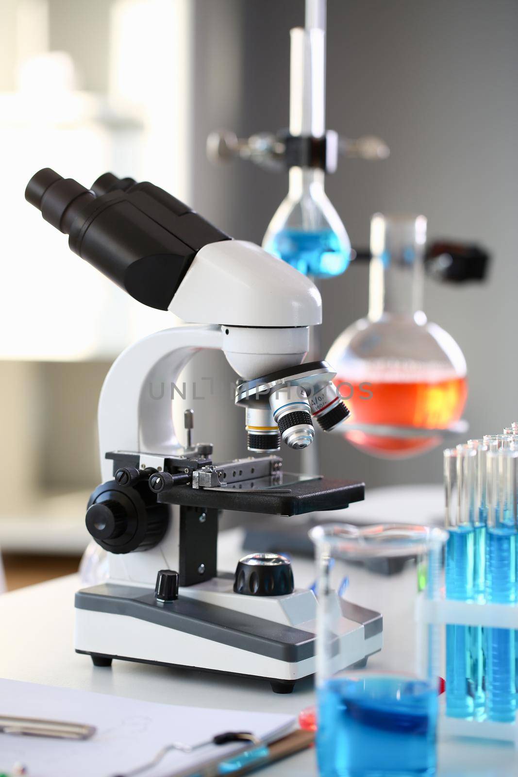 Head microscope on the background laboratory is a study human biology analyzes for non-compliance with the requirements organization public health at international level