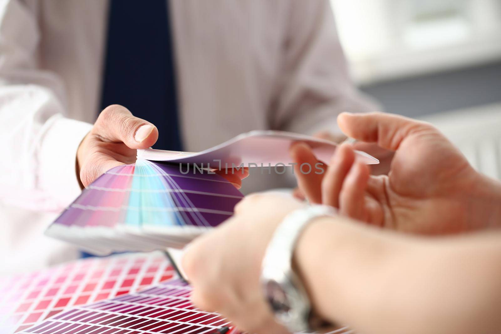 Employee refueling cartridge service holds magnifying glass in hand. Color print of pantone statistics offset organization gives customer an order products for distribution during promotion concept