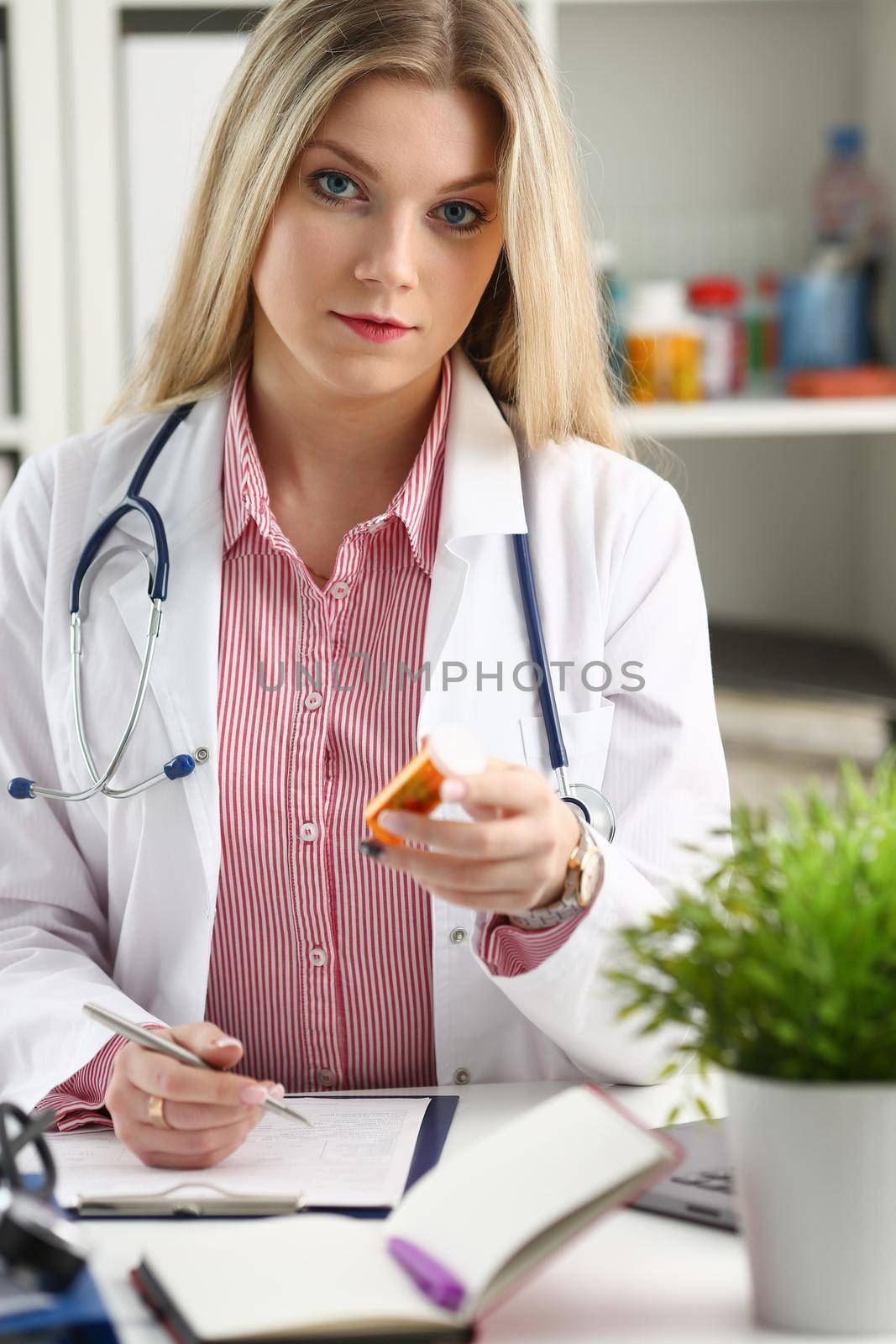 Beautiful smiling female doctor sit at workplace. Physical and disease prevention patient aid exam visit 911 ward round prescribe remedy healthy lifestyle consultant profession concept