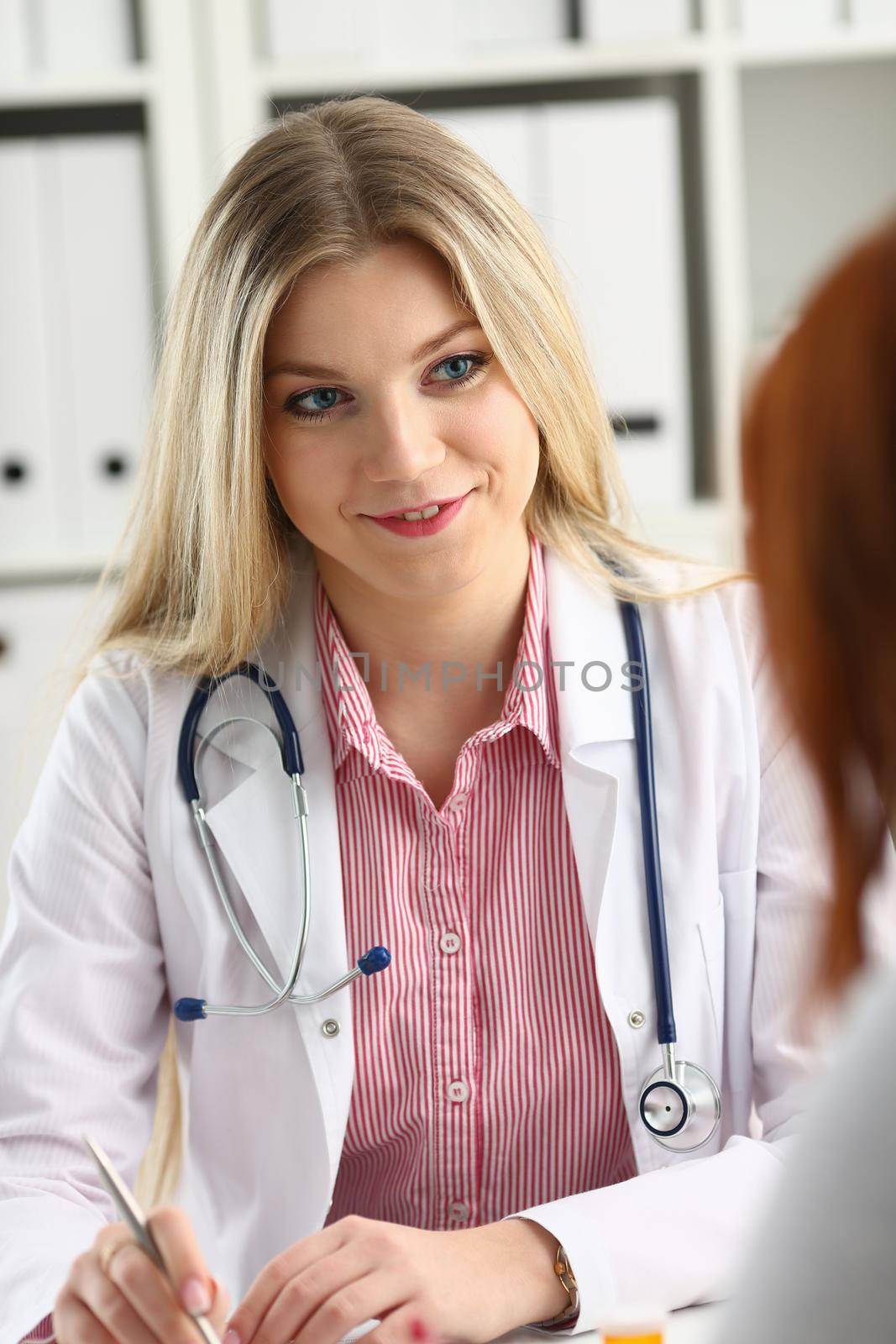 Smiling beautiful female medicine doctor explain diagnosis by kuprevich