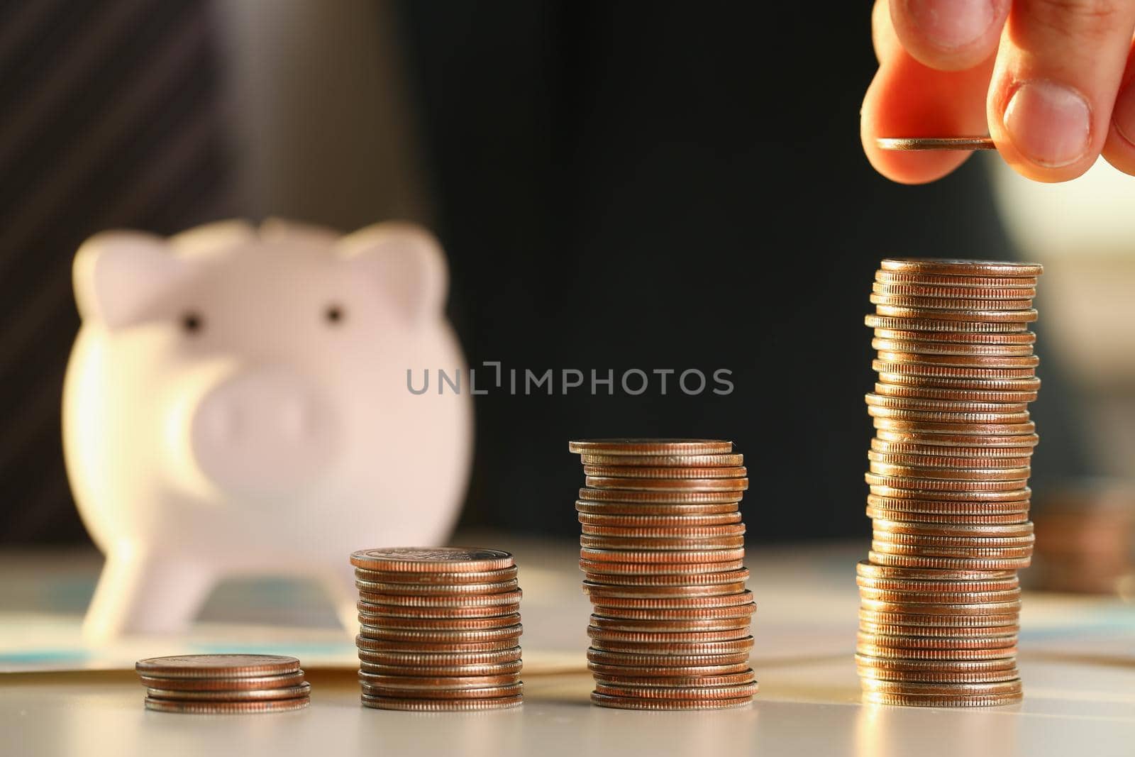 Hand businessman putting pin money into pig by kuprevich