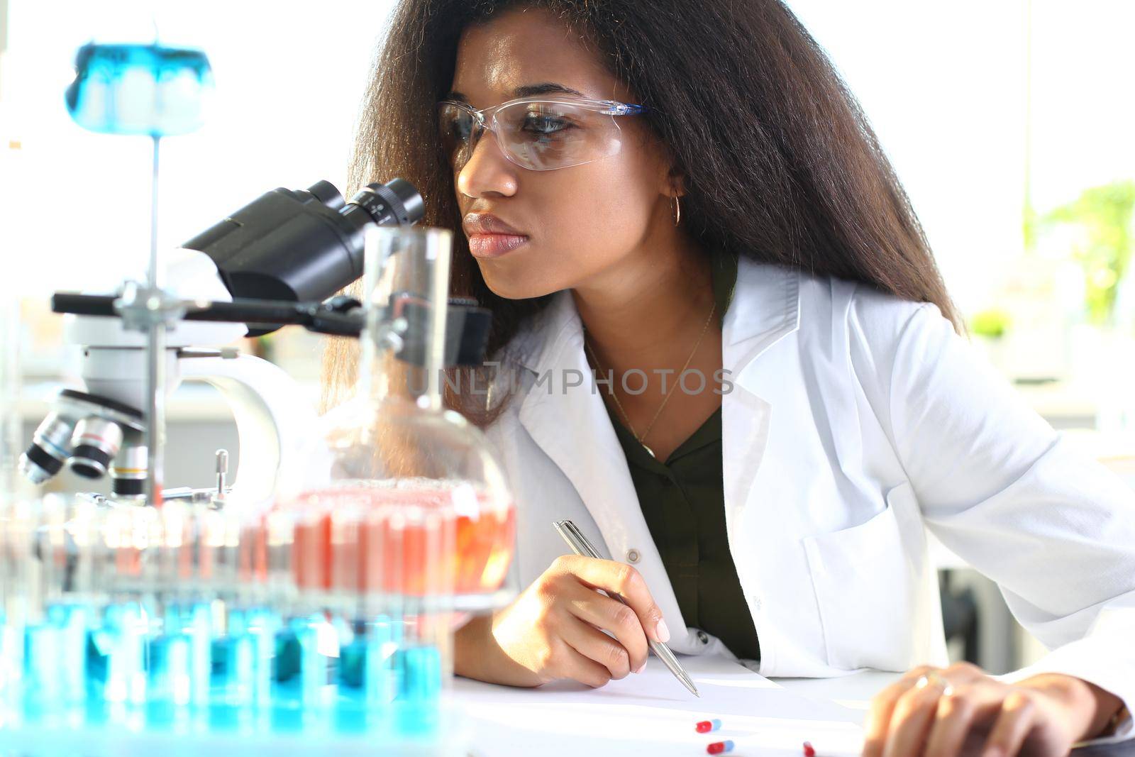 Black woman scientist student chemist in protective by kuprevich