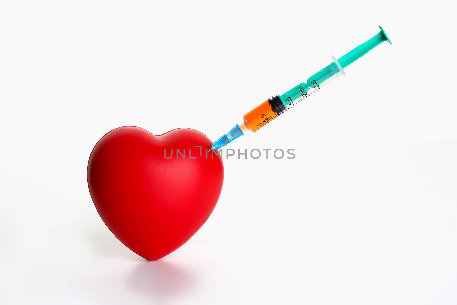 Red heart with stuck syringe on gray background. Cardiac surgery for introduction of an electric pacemaker concept