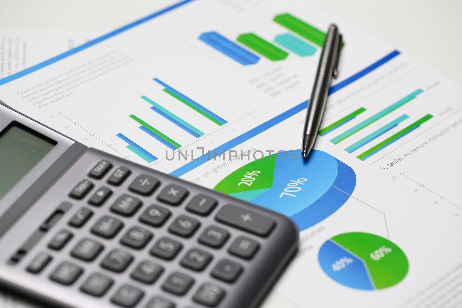Silver calculator and financial statistics on clipboard pad at office table closeup. Internal Revenue Service inspector sum check irs investigation earnings savings loan and credit concept