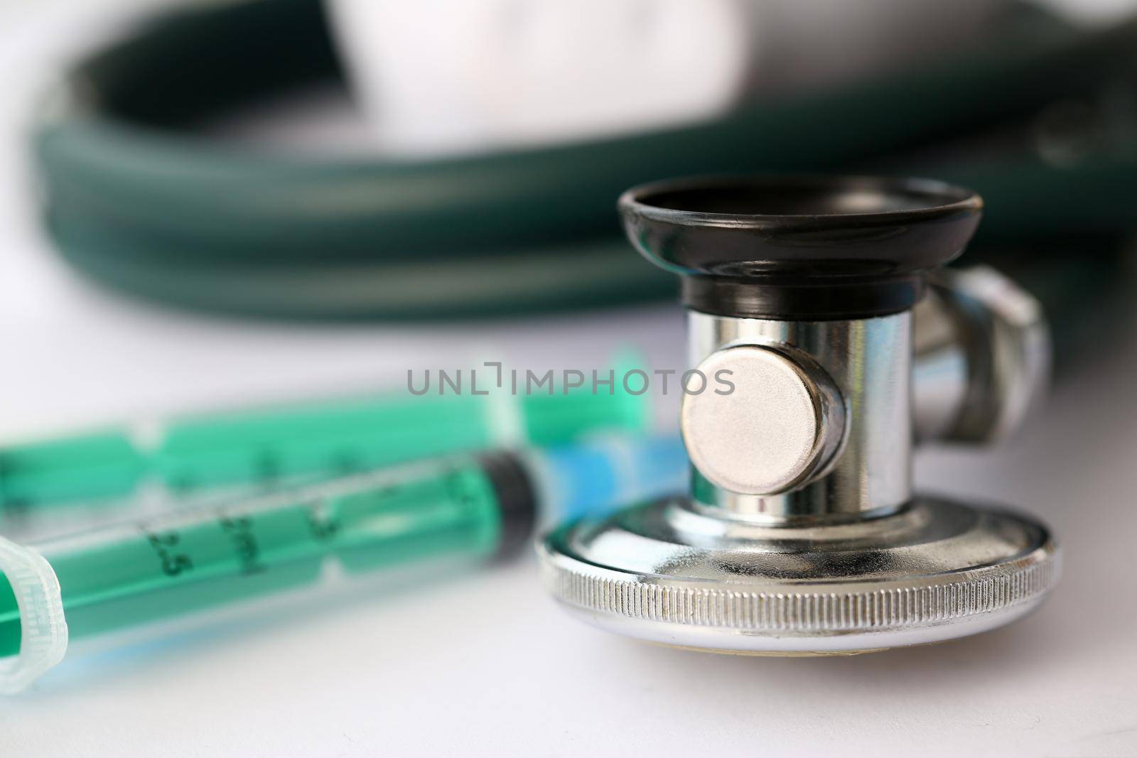 Medical stethoscope lying on paper closeup by kuprevich