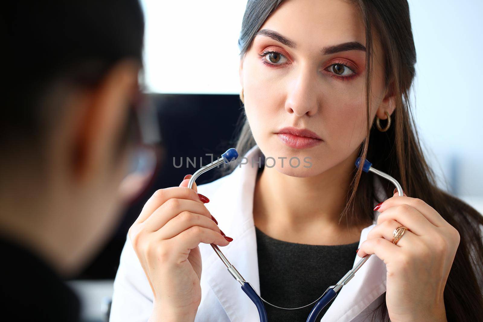 Female doctor hands holding stethoscope in by kuprevich