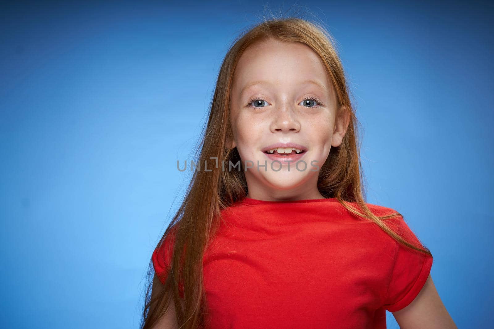 cute red-haired girl in red t-shirt emotions blue background by Vichizh