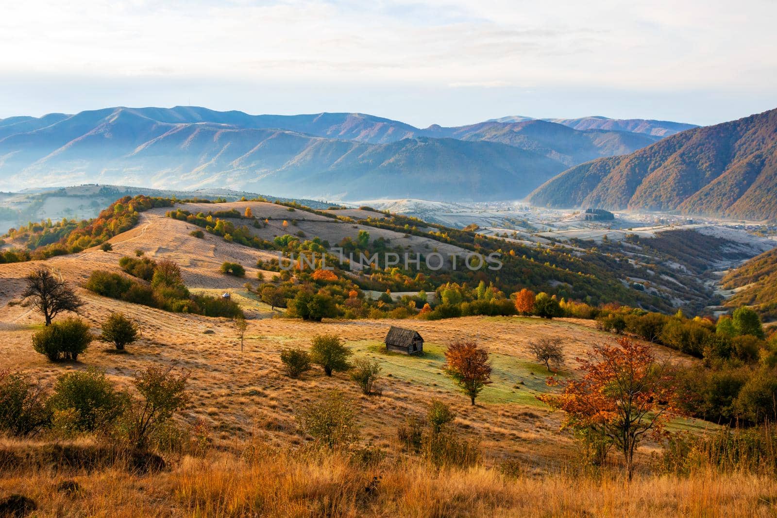 Colorful autumn landscape in the mountain village. Foggy morning in the Carpathian mountains. Pishkonia, Ukraine, Europe. by Andrii