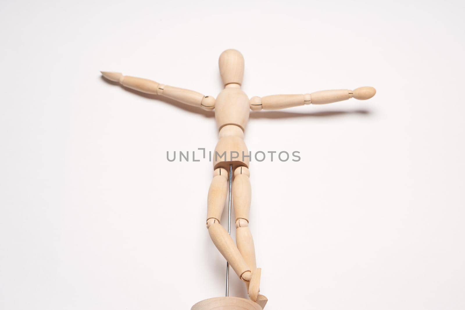 design wooden mannequin object toy posing light background. High quality photo
