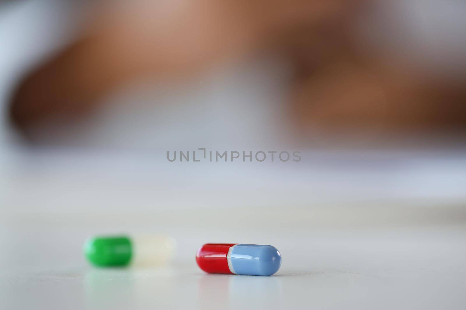 Tablets scattered blue and red color on the table of pharmaceutical laboratory pill for the prescription and treatment various diseases chemistry