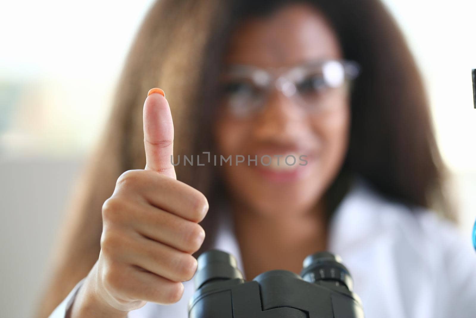 Female black doctor show ok or confirm sign with thumb up portrait. High level therapy great heal participation healthy lifestyle satisfied patient therapeutist arm best consultation physical