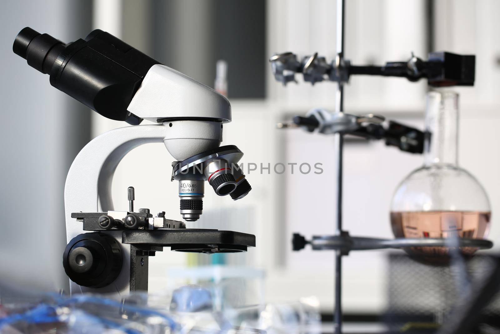 Head microscope on the background laboratory is a study human biology analyzes for non-compliance with the requirements organization public health at international level