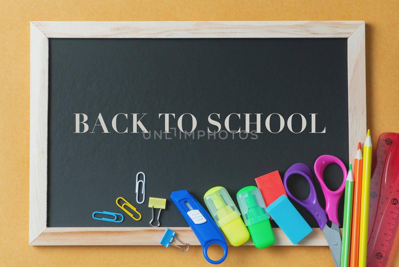 School supplies on black board background. Back to school concept