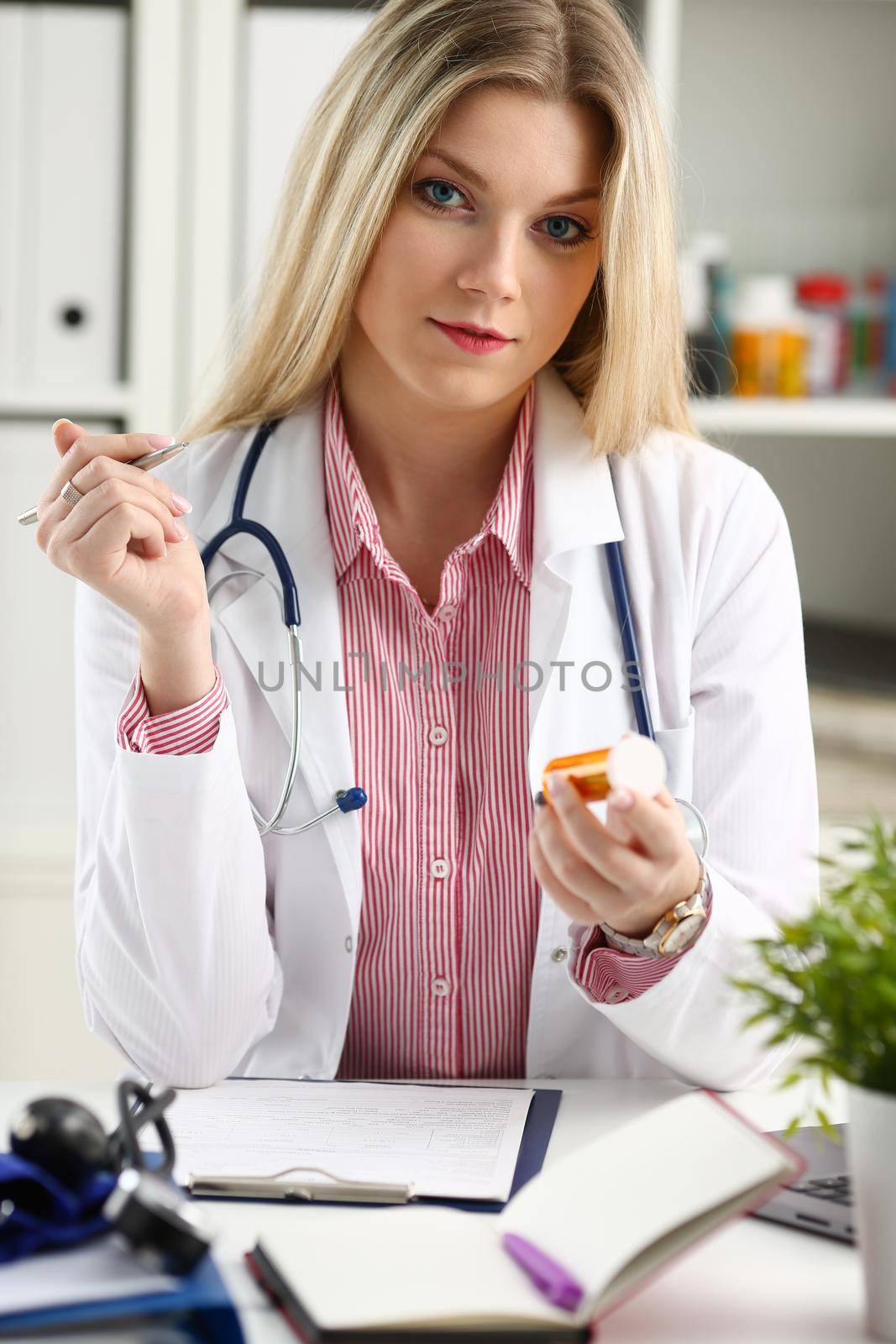 Beautiful smiling female doctor sit at workplace. Physical and disease prevention patient aid exam visit 911 ward round prescribe remedy healthy lifestyle consultant profession concept