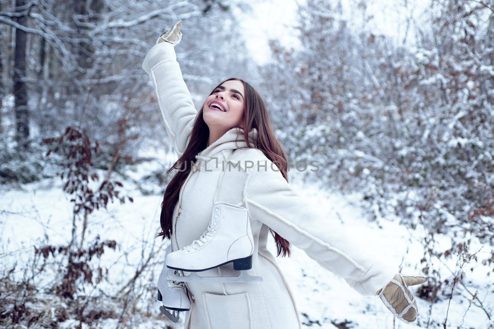 Winter woman. Winter portrait of young beautiful excited amazed brunette woman in snow Garden. Winter concept. Winter woman fan