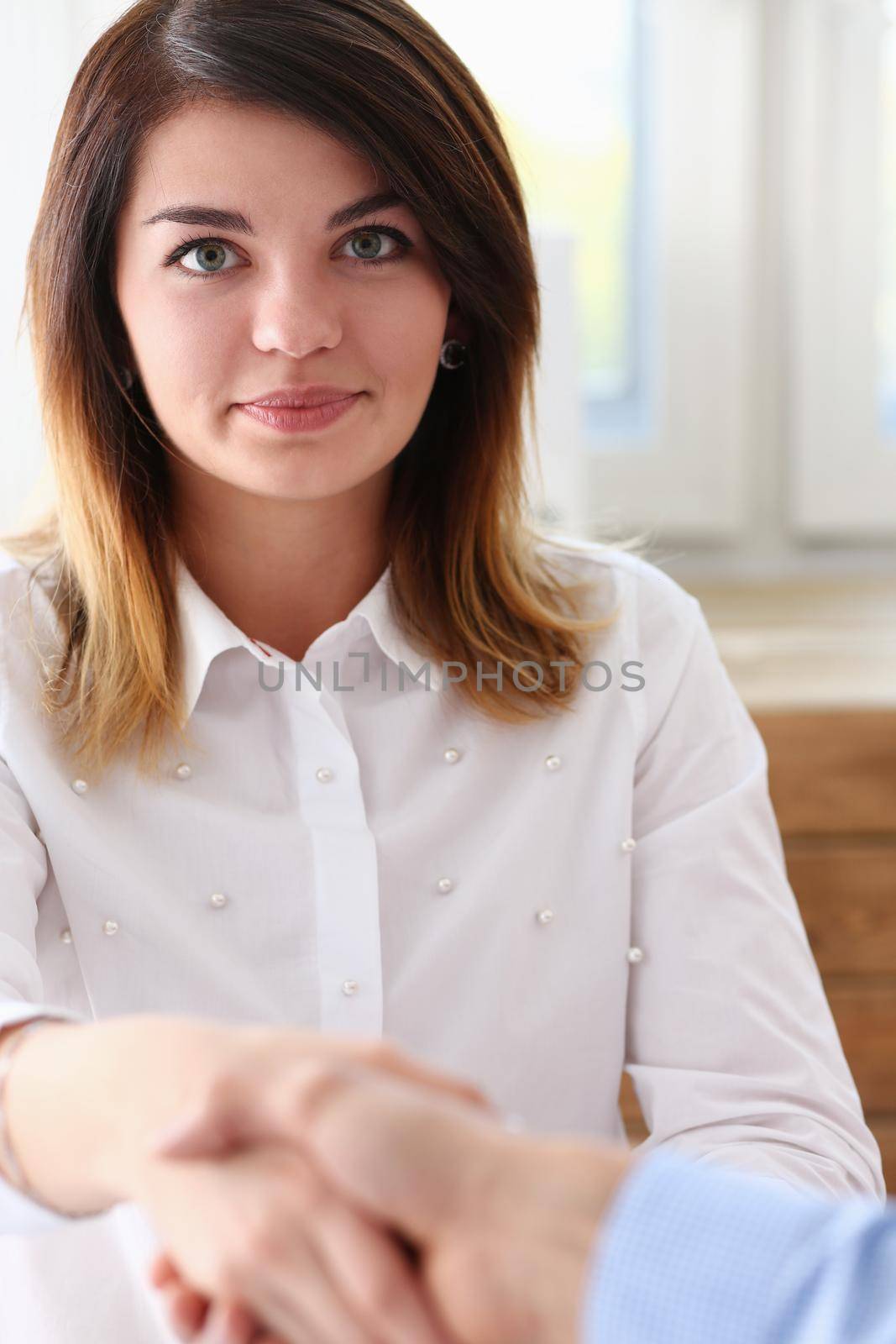 Businessman and woman shake hands as hello in office closeup. Friend welcome introduction greet or thanks gesture product advertisement partnership approval arm strike a bargain on deal concept