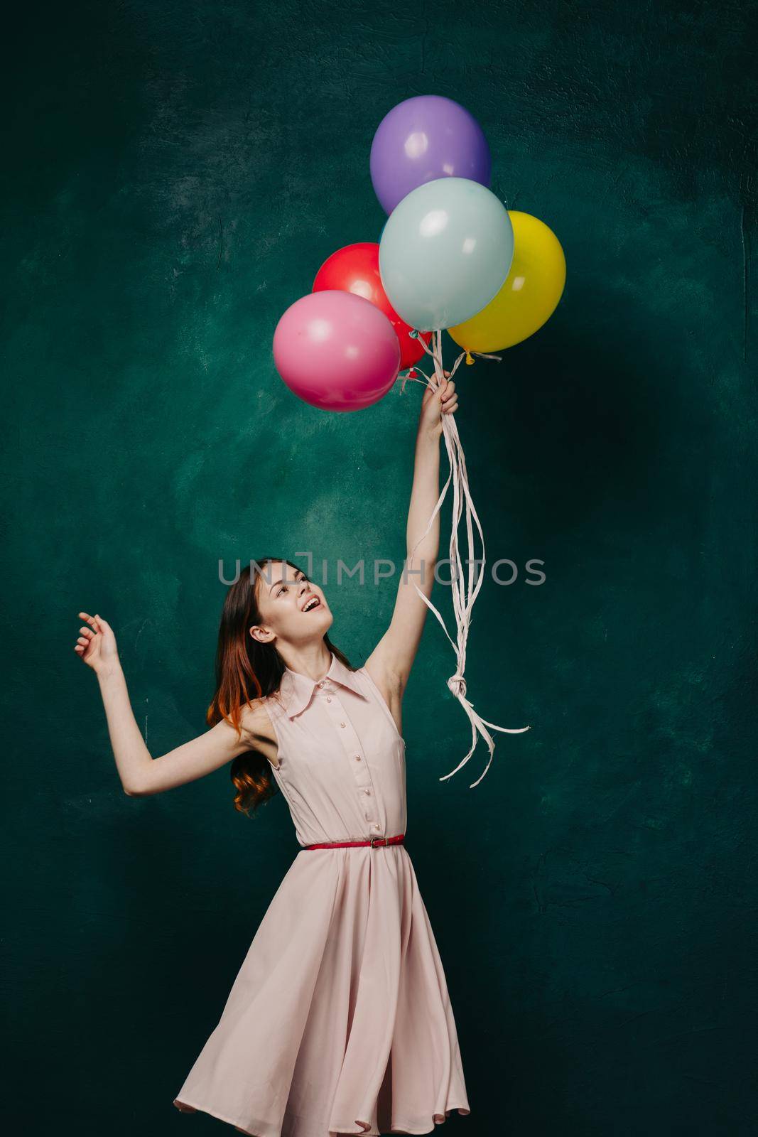 cheerful woman with colorful balloons birthday fun. High quality photo