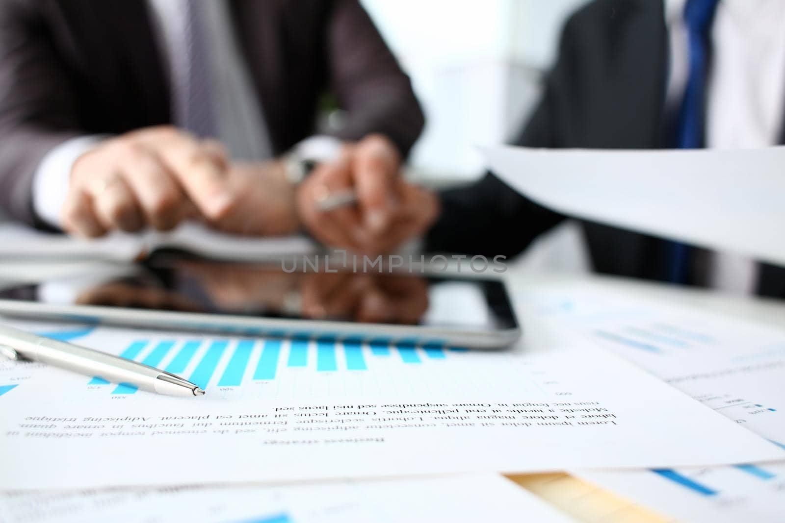 Financial statistics documents ball pen infographics at office table closeup. Internal Revenue Service inspector sum check investigation exchange market earnings savings loan and credit concept