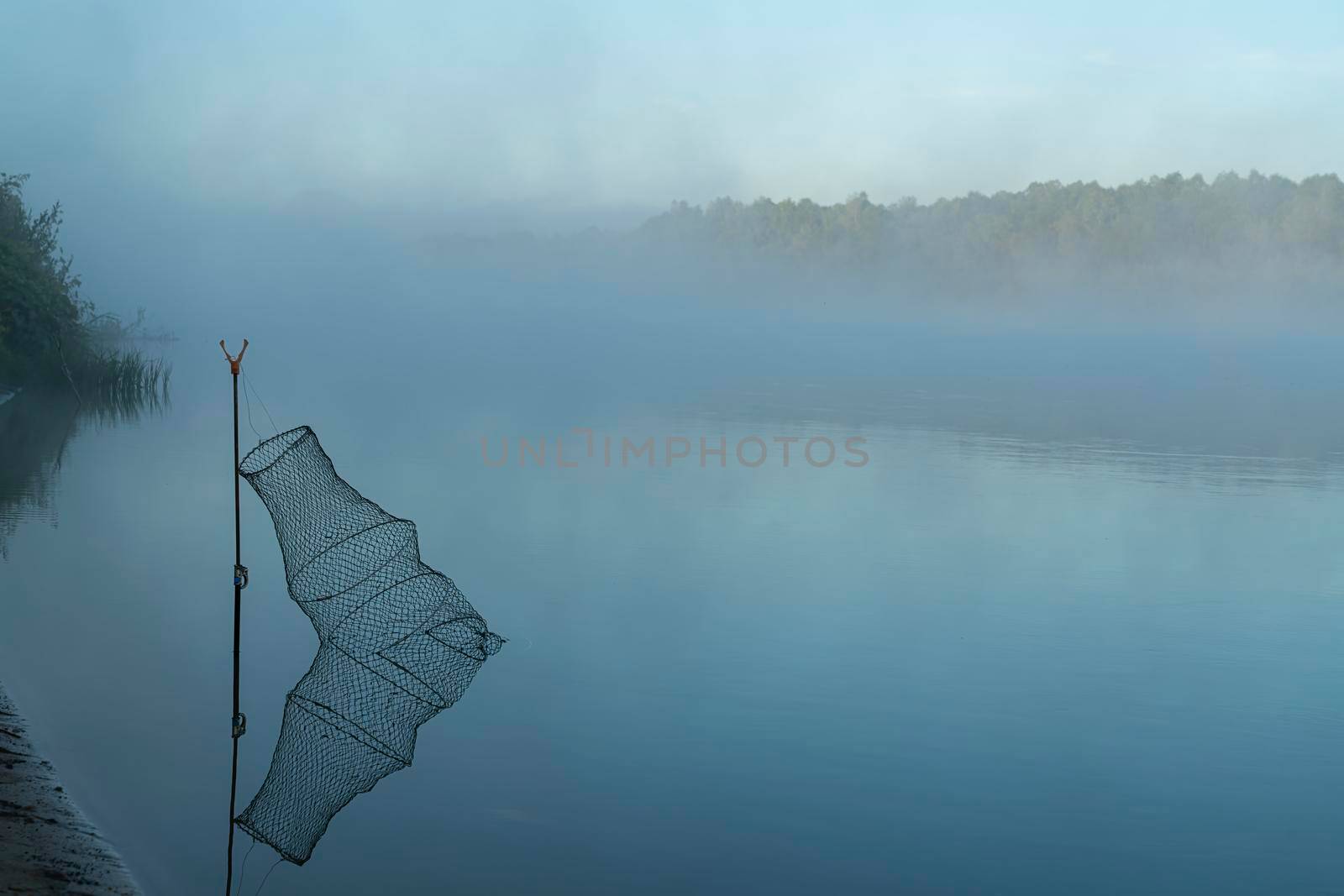 morning fog on the river while fishing. High quality photo